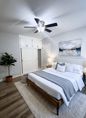 Los Angeles apartment for rent - A bedroom with a bed, a ceiling fan, and a painting on the wall.