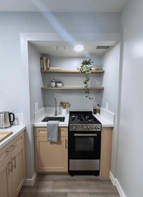 Los Angeles apartment for rent - A kitchen with a black stove top oven and wooden cabinets.