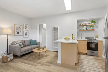 Los Angeles apartment for rent - A modern kitchen and living room with a grey couch and wooden coffee table.