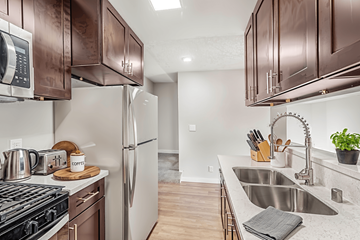 Los Angeles apartment for rent - A kitchen with brown cabinets and a stove top oven.
