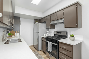 Van Nuys apartment for rent - A modern kitchen with brown cabinets and stainless steel appliances.