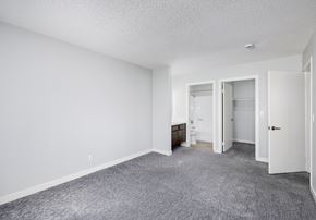 Van Nuys apartment for rent - A sparsely furnished room with a carpeted floor and white walls.