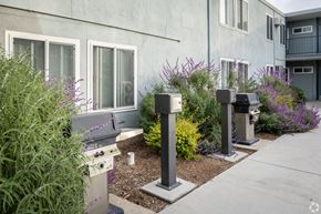 Van Nuys apartment for rent - A grey building with a grey wall and a grey door with a grey window.