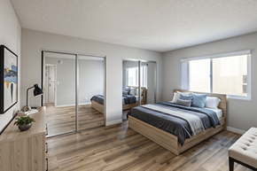 Los Angeles apartment for rent - A bedroom with a large bed and a wooden floor.