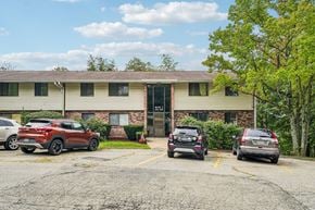 White Oak apartment for rent - A parking lot with cars and a building in the background.