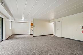 White Oak apartment for rent - A spacious room with a carpeted floor and white walls.