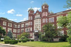 New Kensington apartment for rent - A large red brick building with a green dome on top.
