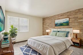 Turtle Creek apartment for rent - A bedroom with a white bed and a painting on the wall.