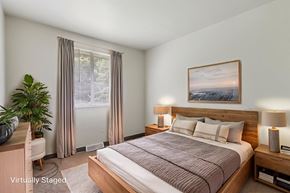Turtle Creek apartment for rent - A bedroom with a large bed and a painting on the wall.