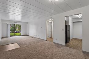 Swissvale apartment for rent - A spacious room with a carpeted floor and a slanted ceiling.