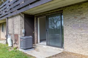 Elizabeth apartment for rent - A grey air conditioning unit sits outside a brick building.