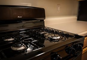 White Oak apartment for rent - A black stove top with a silver oven.
