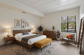 Swissvale apartment for rent - A bedroom with a bed, nightstands, and a chair.
