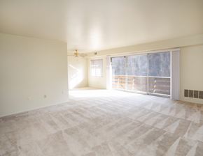 Butler apartment for rent - A large, empty room with a carpeted floor and a ceiling fan.