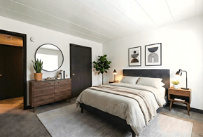 Wilkins Twp apartment for rent - A bedroom with a bed, nightstand, and a plant.