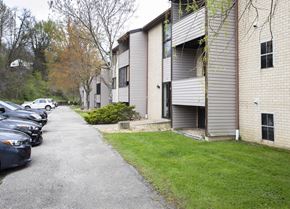 North Huntington apartment for rent - A parking lot with cars and apartment buildings.