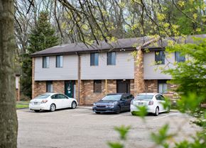 Turtle Creek apartment for rent - Three cars are parked in front of a brick building.