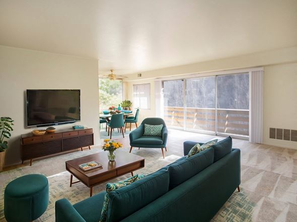 Butler apartment for rent - A living room with a green couch and a wooden coffee table.