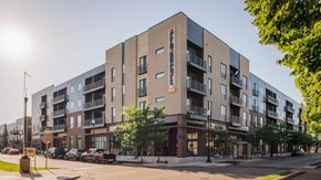Evansville apartment for rent - A modern apartment building with a parking lot in front.
