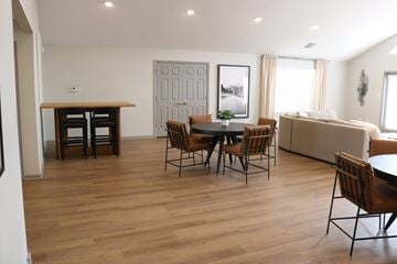 Evansville apartment for rent - A living room with a dining table and chairs.