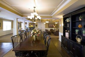 Avon apartment for rent - A dining room with a long table set for a meal.