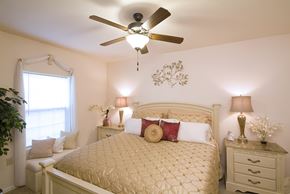 Avon apartment for rent - A bedroom with a bed, nightstands, and a ceiling fan.
