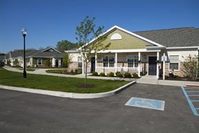 Avon apartment for rent - A parking lot with a handicap parking space in front of a building.
