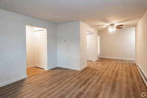 Michigan City apartment for rent - A room with wooden floors and white walls.