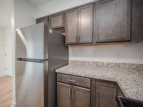 Evansville apartment for rent - A kitchen with a refrigerator and cabinets.