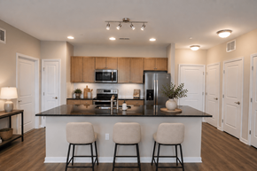Bear triplex for rent - A kitchen with a black countertop and white walls.