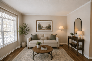 Newark apartment for rent - A living room with a couch, a coffee table, and a painting on the wall.