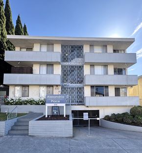 Los Angeles apartment for rent - A modern building with the sign "Alexandria Place 410" in front of it.