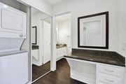 Los Angeles apartment for rent - A white kitchen with a granite counter top and a refrigerator.