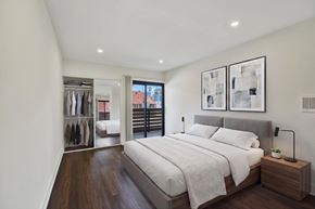 Los Angeles apartment for rent - A bedroom with a large bed and a wooden nightstand.