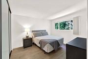 Los Angeles apartment for rent - A bedroom with a bed, nightstand, and lamp at Westwood Riviera Apartments, Los Angeles, California