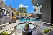 Los Angeles apartment for rent - A hot tub sits in the middle of a patio with a white bench and a black table at Westwood Riviera Apartments, Los Angeles, 90024