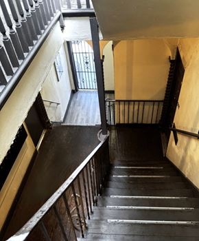 Los Angeles apartment for rent - A staircase with a metal railing and wooden steps.