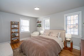 Richmond apartment for rent - A bedroom with a bed, nightstand, and window.