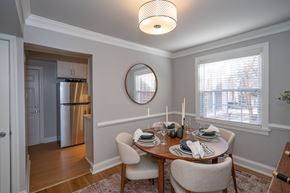 Richmond apartment for rent - A dining room with a table set for two and a refrigerator in the background.