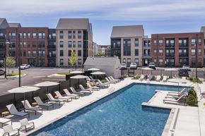 Richmond apartment for rent - A pool surrounded by sun loungers and umbrellas.