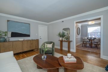 Richmond apartment for rent - A living room with a white couch and a wooden coffee table.