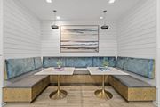 Cranberry Township apartment for rent - A modern dining area with a wooden table and blue cushioned booths.