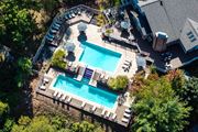 Monroeville apartment for rent - An aerial view of a pool surrounded by trees and a house.