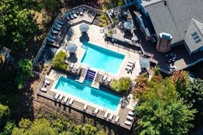 Monroeville apartment for rent - An aerial view of a pool surrounded by trees and a house.