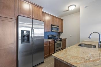 Energy-efficient stainless-steel appliances, including gas range, refrigerator with ice & water dispenser, dishwasher, microwave, and garbage disposal