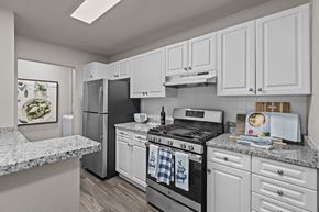 Milford apartment for rent - A kitchen with white cabinets and a marble countertop. at Merion Milford Apartment Homes, Milford, CT