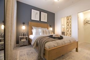 Millsboro apartment for rent - a bedroom with a bed and two lamps and a closet  at Carillon Woods, Millsboro, Delaware