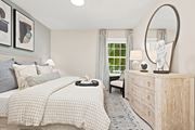 Groton apartment for rent - A bedroom with a large bed and a dresser with a mirror.