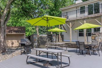 Outdoor patio area with picnic tables and grills