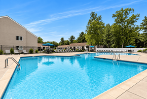 Clifton Park apartment for rent - A large swimming pool with a building in the background.